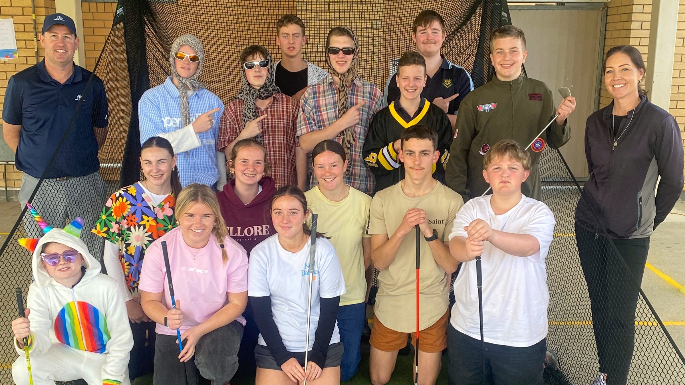Kids in a group with golf clubs in hand